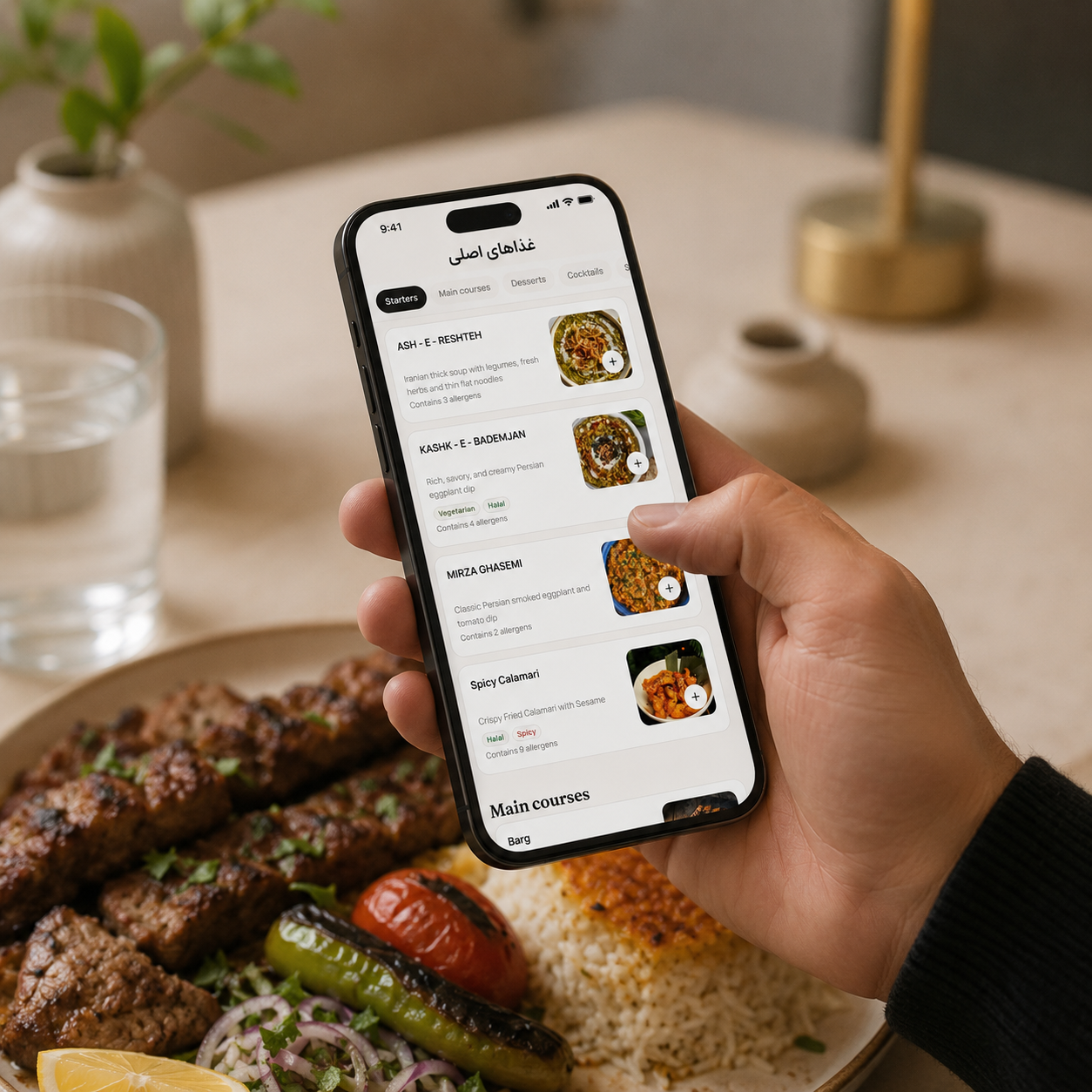 Hand holding a phone showing the Monsieur Click menu over a plate of charcoal-grilled kebabs and saffron rice
